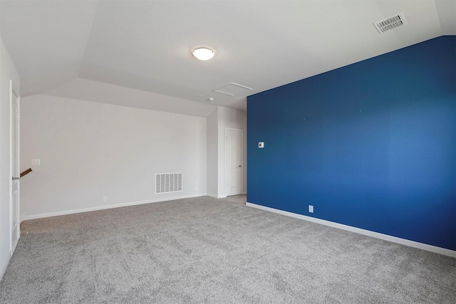 empty room with carpet and lofted ceiling