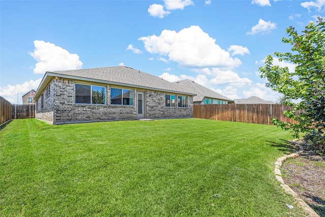 rear view of property with a lawn