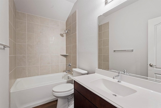 full bathroom featuring vanity, tiled shower / bath combo, hardwood / wood-style flooring, and toilet