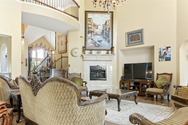 living room with a fireplace and a towering ceiling