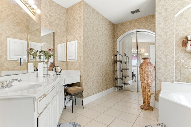 bathroom with a bathtub, tile patterned flooring, and vanity