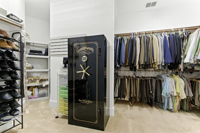 walk in closet with carpet