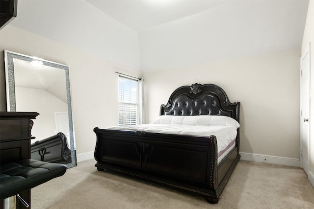 carpeted bedroom featuring lofted ceiling