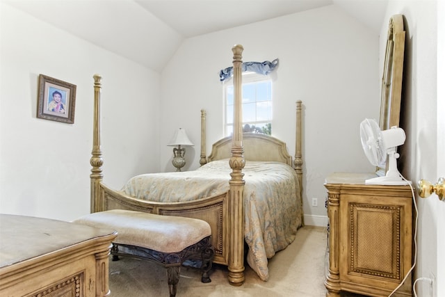 carpeted bedroom with lofted ceiling