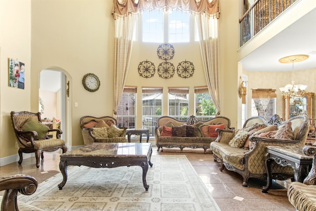 sitting room featuring a chandelier, a high ceiling, and tile patterned floors