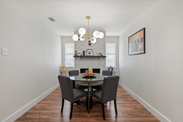 dining space with an inviting chandelier and dark wood-type flooring