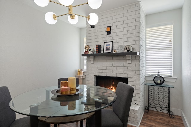 dining space with a fireplace and dark wood-type flooring