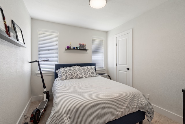 bedroom with multiple windows and carpet