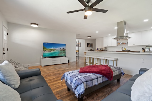 living room with wood-type flooring and ceiling fan