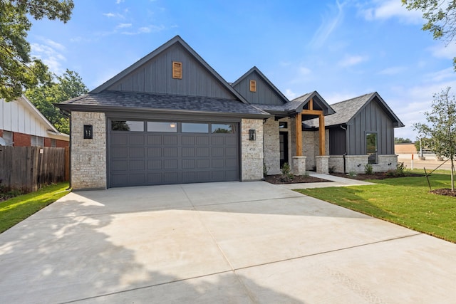 view of front of house with a garage and a front yard