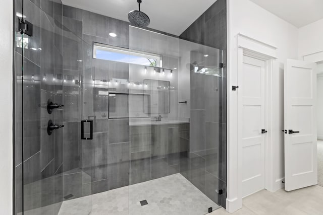 bathroom featuring tile patterned flooring and a shower with shower door