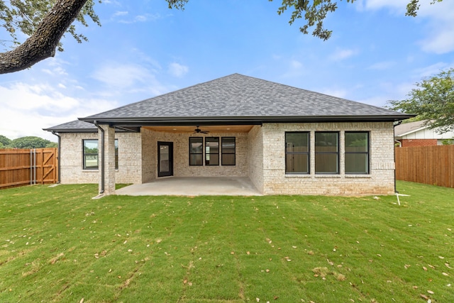 rear view of property featuring a patio area, a lawn, and ceiling fan