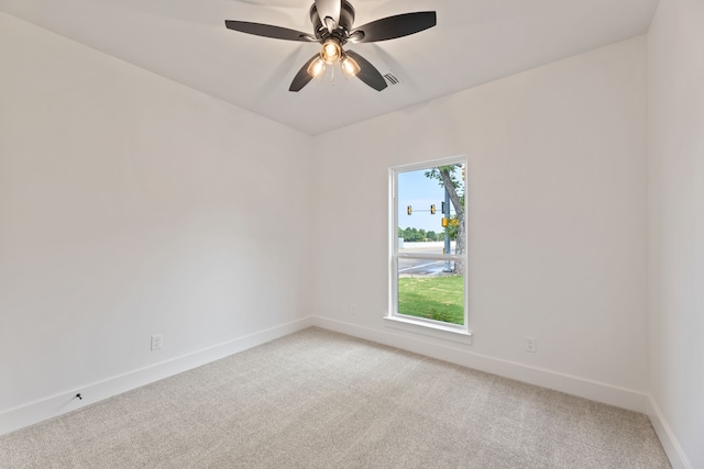 carpeted spare room featuring ceiling fan