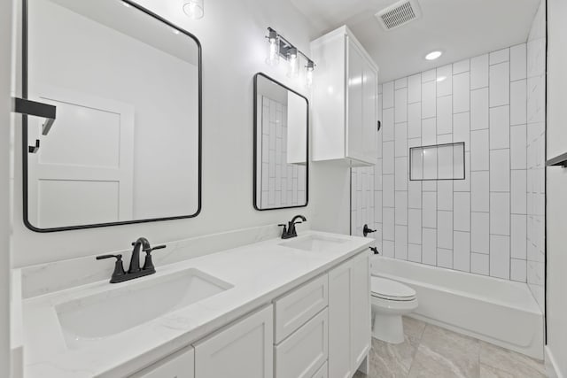 full bathroom with toilet, vanity, and tiled shower / bath