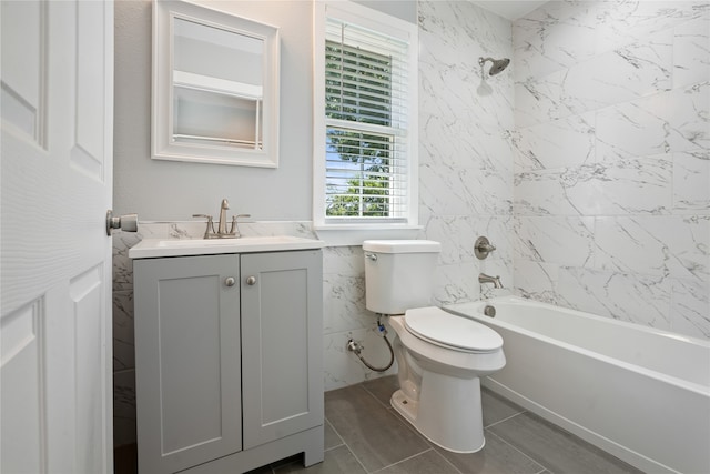 full bathroom featuring tile flooring, vanity, toilet, and tiled shower / bath combo