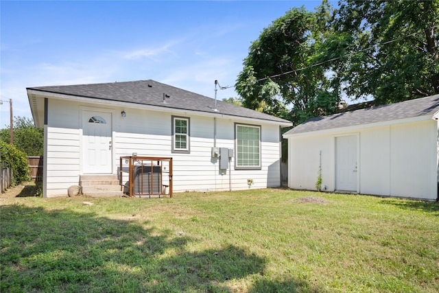 back of house with a lawn