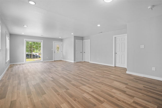 unfurnished living room with wood-type flooring