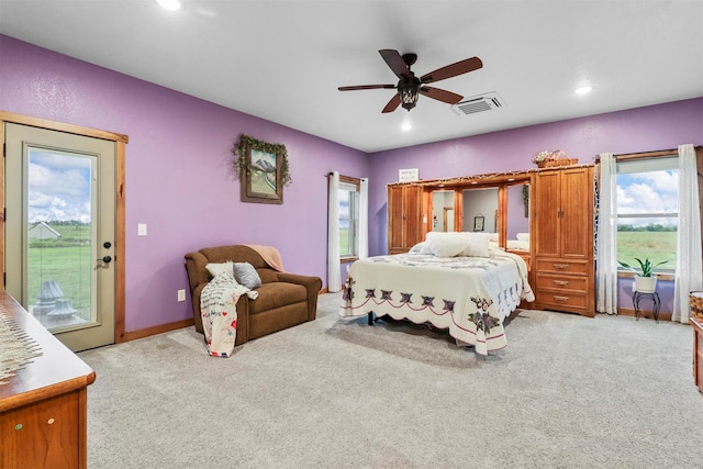 carpeted bedroom featuring ceiling fan and access to exterior