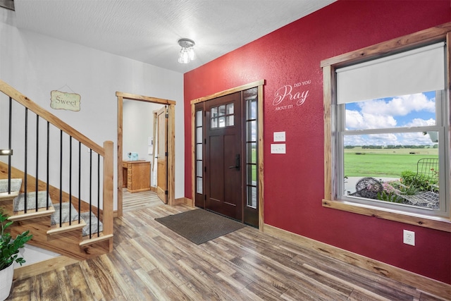 foyer entrance with hardwood / wood-style floors