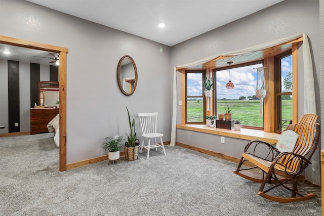 sitting room featuring carpet flooring and ceiling fan