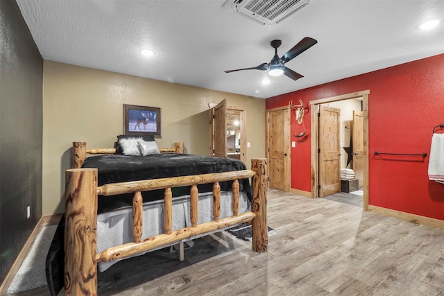 bedroom with connected bathroom, ceiling fan, and hardwood / wood-style floors