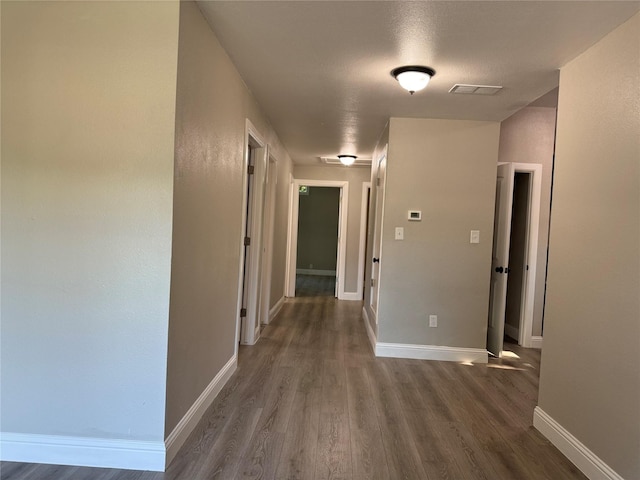 hall featuring dark hardwood / wood-style floors and a textured ceiling