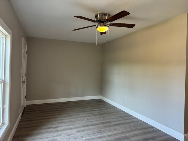 unfurnished room with hardwood / wood-style floors, ceiling fan, and a healthy amount of sunlight