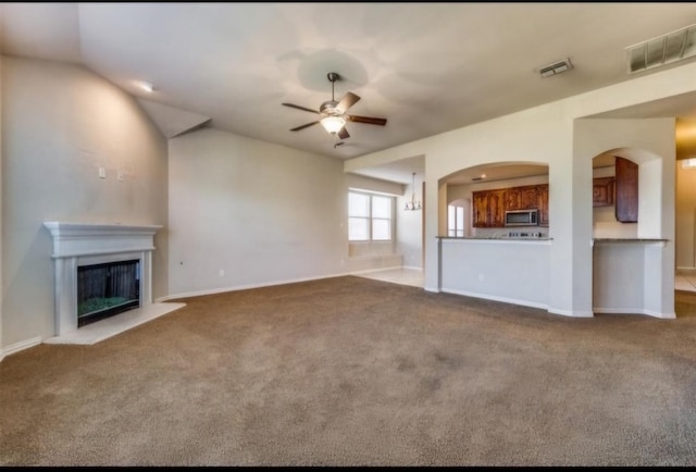 unfurnished living room featuring light carpet and ceiling fan