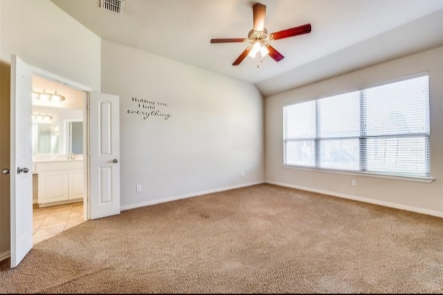 spare room with ceiling fan and light colored carpet