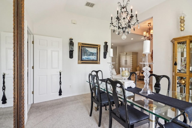 carpeted dining area with visible vents and an inviting chandelier