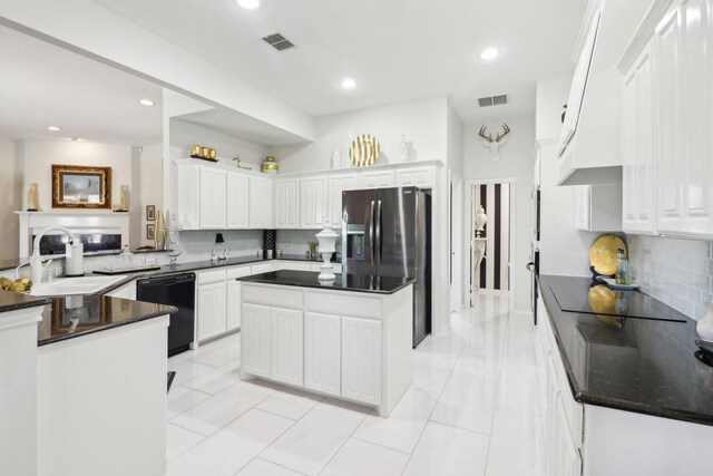 kitchen featuring backsplash, white cabinets, light tile patterned floors, sink, and black appliances