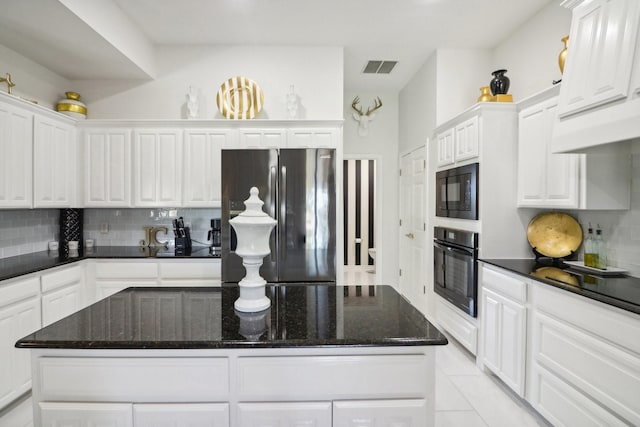 kitchen featuring black appliances, tasteful backsplash, and white cabinets