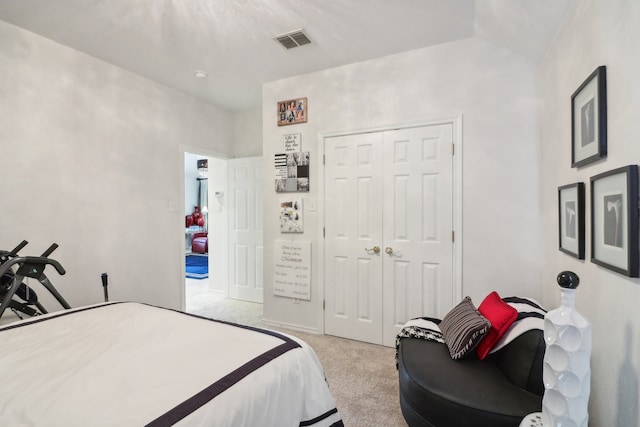 bedroom with light colored carpet and a closet