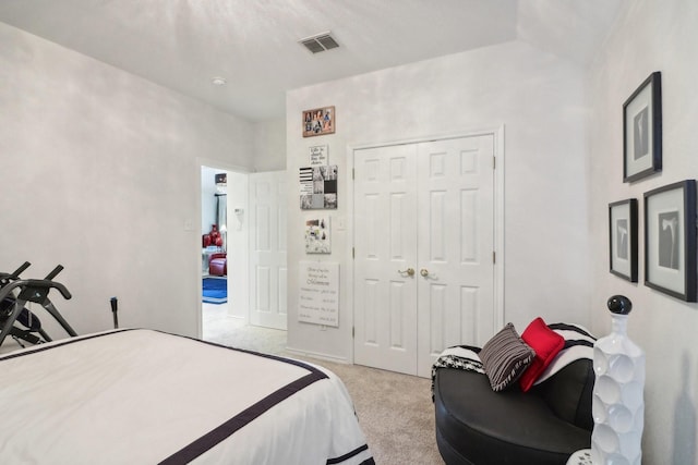 carpeted bedroom featuring a closet and visible vents