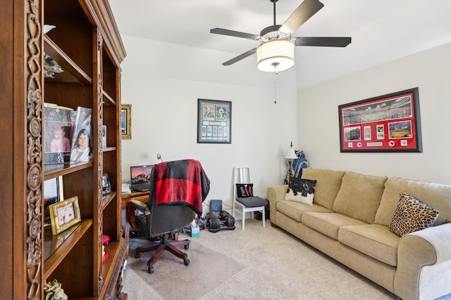 carpeted home office with ceiling fan