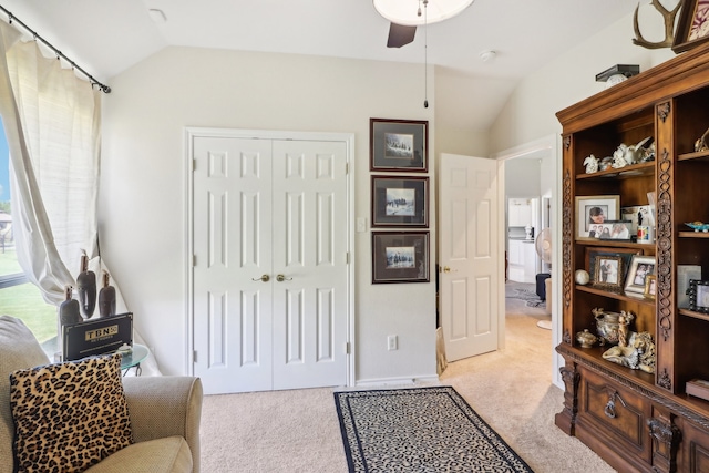 sitting room with ceiling fan, light carpet, and lofted ceiling