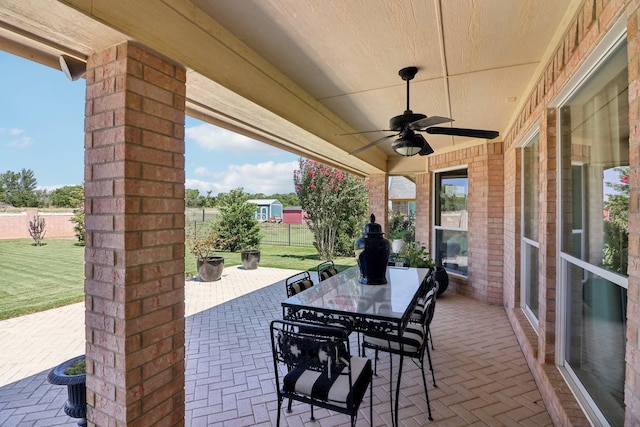 view of patio / terrace with fence, a ceiling fan, and outdoor dining space