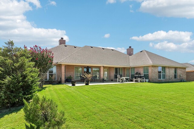 rear view of property featuring a patio area and a yard