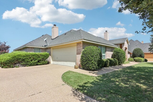 view of front facade with a front yard and a garage