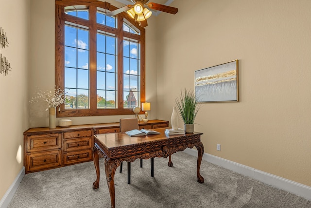 office featuring ceiling fan, light colored carpet, and vaulted ceiling