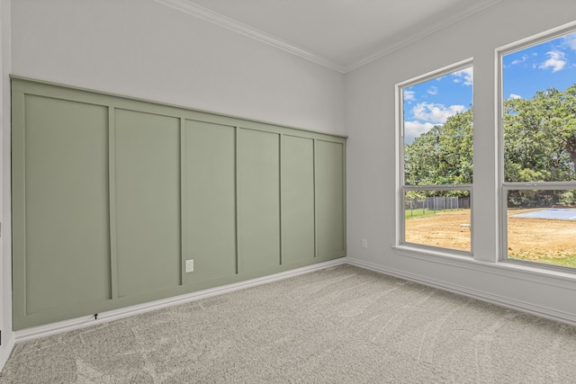 spare room featuring crown molding and light colored carpet