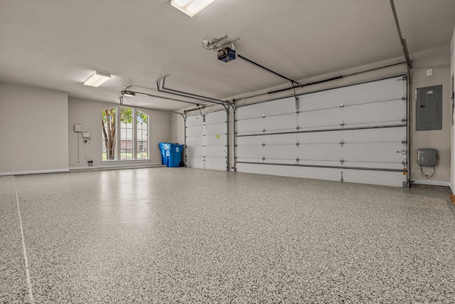 garage with a garage door opener and electric panel