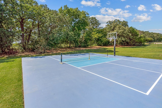 view of tennis court featuring a lawn and basketball court