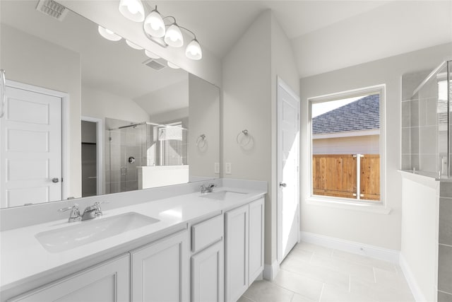 bathroom featuring vanity, an enclosed shower, tile patterned flooring, and vaulted ceiling