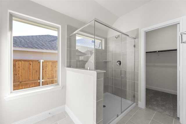 bathroom with walk in shower and tile patterned flooring