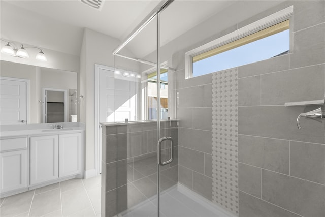 bathroom featuring vanity, tile patterned floors, and an enclosed shower