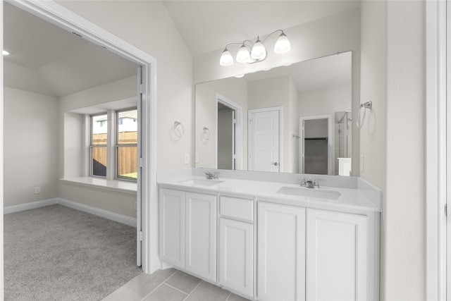 bathroom with vanity, lofted ceiling, and tile patterned floors