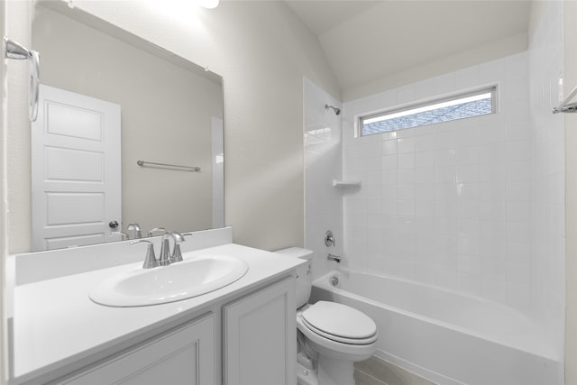 full bathroom featuring vanity, toilet, tiled shower / bath combo, and vaulted ceiling