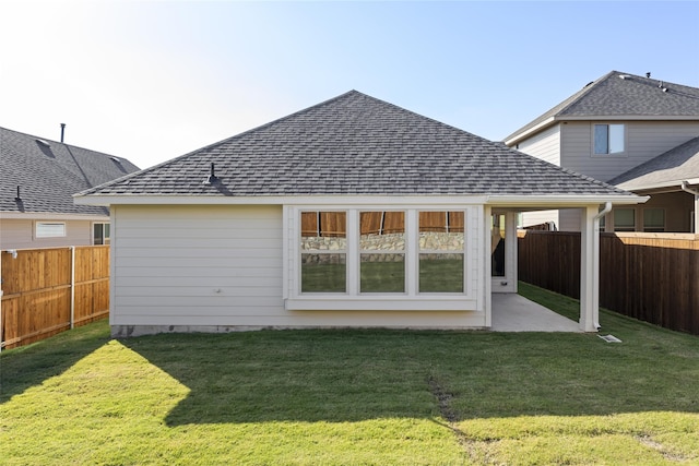 back of house featuring a yard and a patio