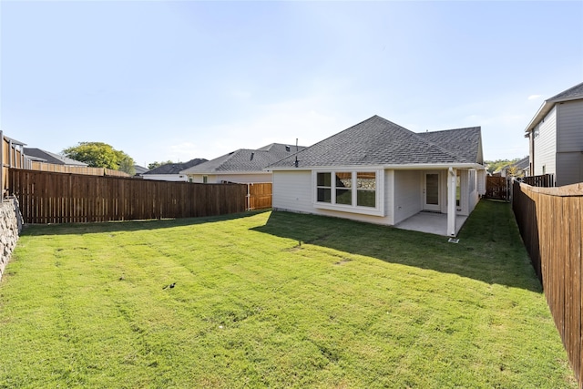 back of house featuring a patio and a lawn